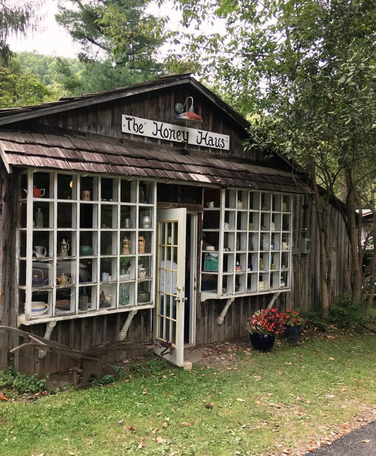 The Honey Haus, a rustic wooden shop with window displays, at Helvetia fair