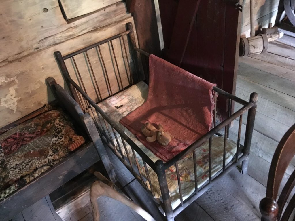 Antique wooden cradle on display in historic building